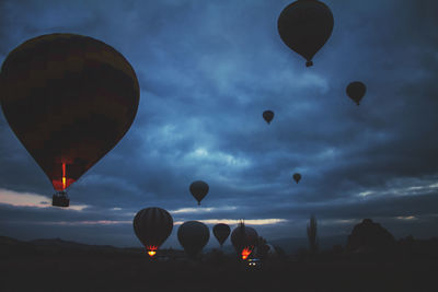 Low angle view of hot air balloons flying in sky