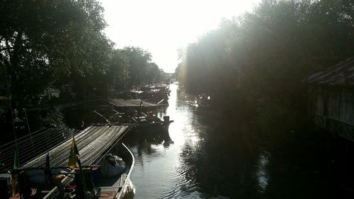 Boats moored in river against sky