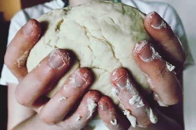 Close-up midsection of woman holding dough