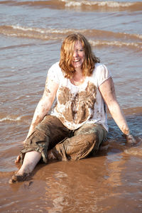 Portrait of woman sitting at beach