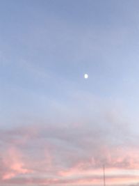 Low angle view of moon against sky at sunset