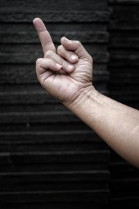 Close-up of person hand on wood