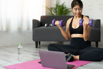 Young woman exercising in gym