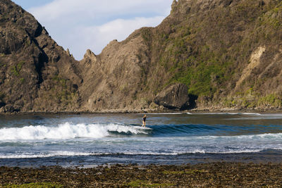 Female surfer on a wave, sumbawa, indonesia