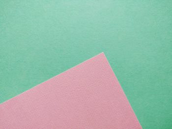 Close-up of pink over green background