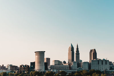 Buildings in city against clear sky