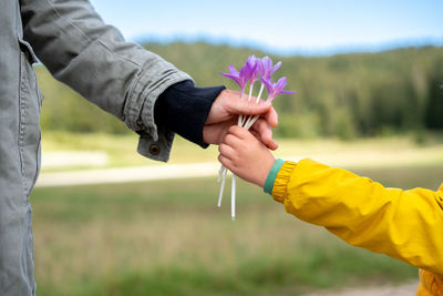 A child giving flowers to woman as a sign of love gift