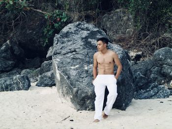 Portrait of young man standing on rock