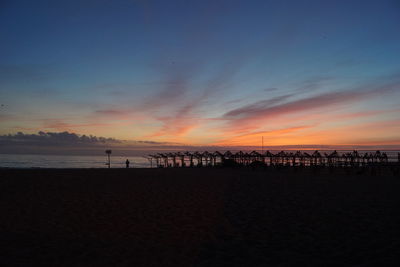 Scenic view of beach against sky during sunset