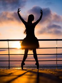 Silhouette of woman at sunset