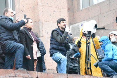 Group of people sitting in front of building