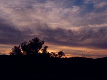 Silhouette trees against sky during sunset