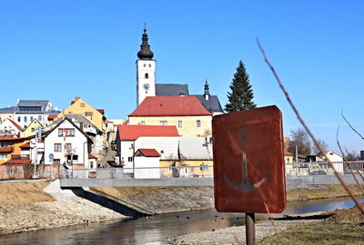 View of buildings against clear blue sky