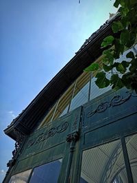 Low angle view of text on building against sky