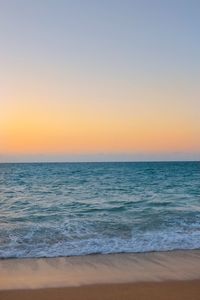 Scenic view of sea against clear sky during sunset