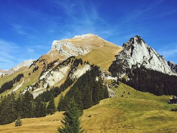 Low angle view of mountains against blue sky