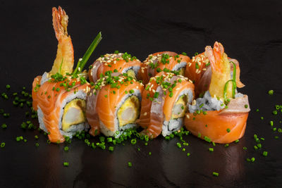 Close-up of sushi on black background