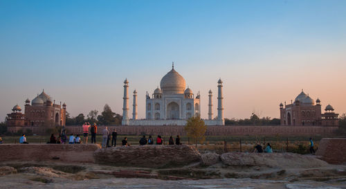 Facade of temple against clear sky at sunset