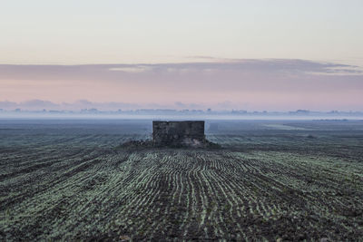 Scenic view of land against sky during sunset