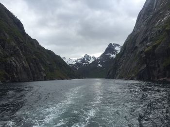 Scenic view of mountains against cloudy sky