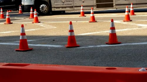 Close-up of traffic cones on road in city