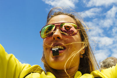 Low angle view of sunglasses against blue sky