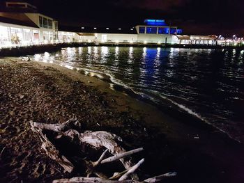 Illuminated city against sky at night