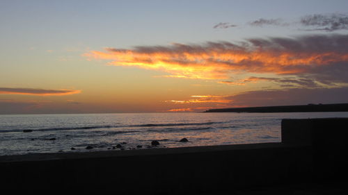 Scenic view of sea against dramatic sky