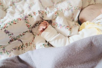 High angle view of baby lying down on bed