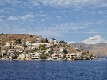 Town by sea against sky