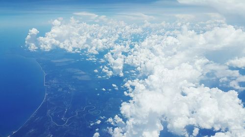 Aerial view of sea against cloudy sky