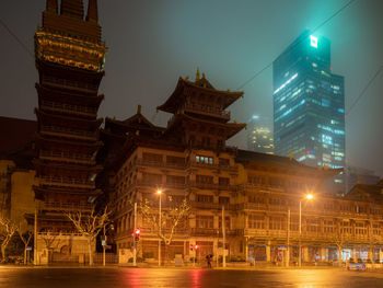 Illuminated buildings in city at night