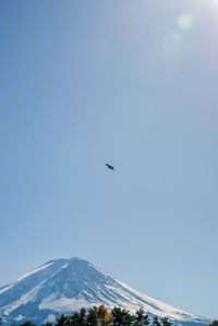 Low angle view of airplane flying against clear sky