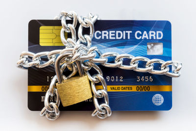 Close-up of padlocks against white background