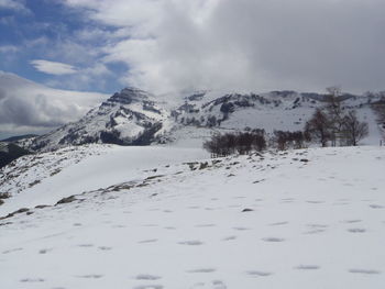 Scenic view of snowcapped mountains against sky