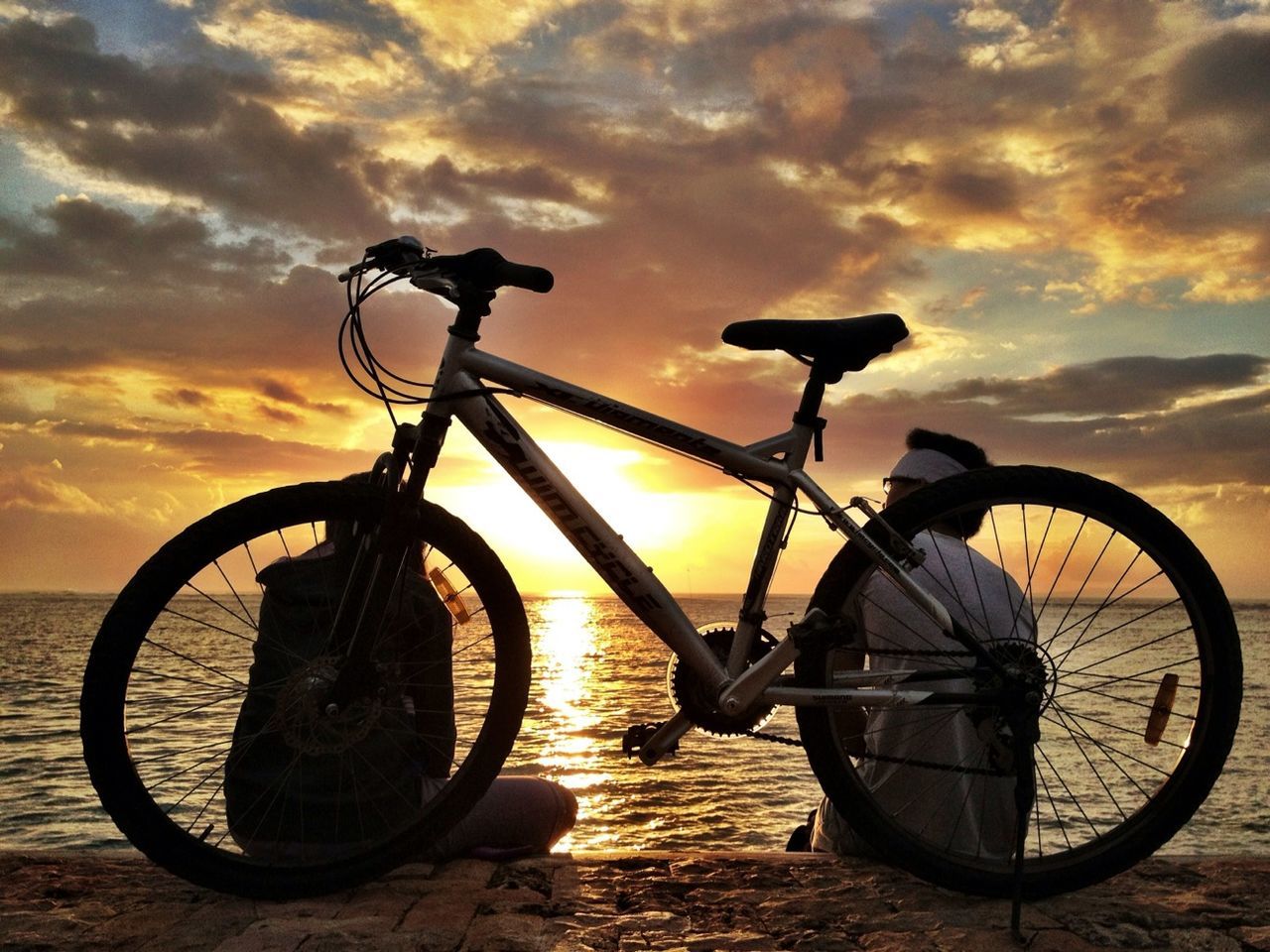 bicycle, sunset, sky, transportation, mode of transport, land vehicle, cloud - sky, stationary, parking, orange color, parked, silhouette, cloud, tranquility, wheel, cloudy, scenics, dramatic sky, no people, beauty in nature