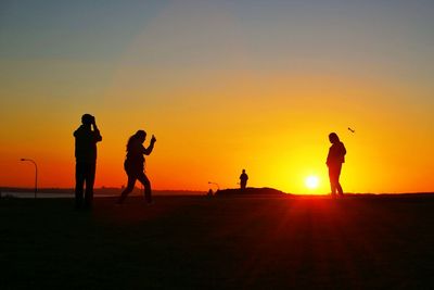 Silhouette of people at sunset