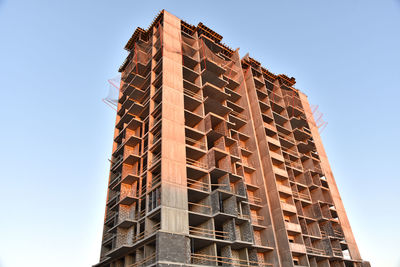 Construction the high-rise building. new residential skyscraper on blue sky background. 