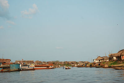 View of townscape by sea against sky