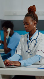 Female doctor examining patient at clinic