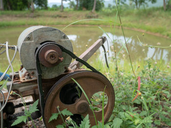 Old rusty wheel on field