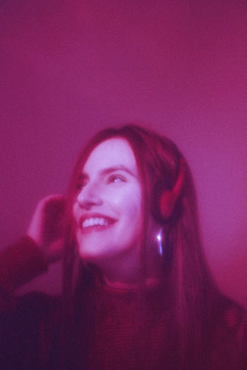 Smiling young woman wearing headphones