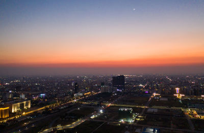 High angle view of illuminated buildings against sky during sunset