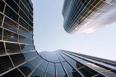Spain, catalonia, barcelona, directly below view of modern glass skyscraper