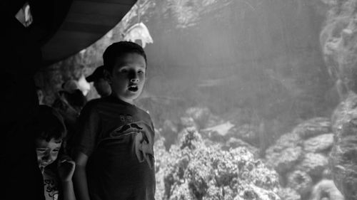 Portrait of boy looking at waterfall