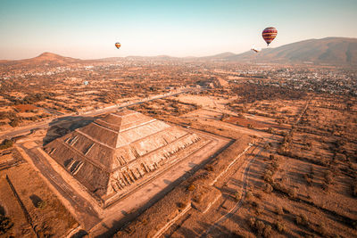 Aerial view of hot air balloon flying over landscape