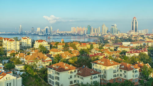 A view of the red roofs of downtown qingdao and tourist landmarks from the top of the hill.