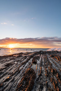 Scenic view of beach against sky during sunset