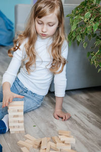 Girl playing django on the floor