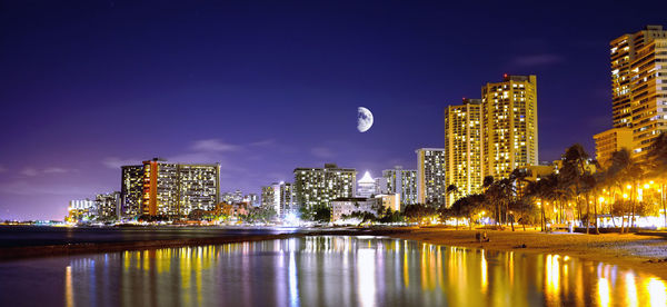 Illuminated buildings in city at night